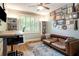 Inviting room with hardwood floors, custom desk, ample storage, leather couch and window with light streaming through at 374 Beaumont Farms Dr, Sharpsburg, GA 30277