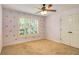 Bedroom with plush carpet, shuttered windows and gold crown wallpaper at 374 Beaumont Farms Dr, Sharpsburg, GA 30277