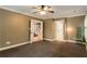 Bedroom with neutral walls and carpeted floor leading to other rooms at 374 Beaumont Farms Dr, Sharpsburg, GA 30277