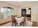 Elegant dining room with hardwood floors, chandelier, large window, and decorative furnishings at 374 Beaumont Farms Dr, Sharpsburg, GA 30277