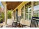 Inviting front porch with rocking chairs and wood ceiling at 374 Beaumont Farms Dr, Sharpsburg, GA 30277