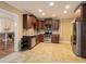 Spacious kitchen with stainless steel appliances and lots of dark wood cabinets at 374 Beaumont Farms Dr, Sharpsburg, GA 30277