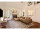 Bright living room with fireplace, hardwood floors, and large windows at 374 Beaumont Farms Dr, Sharpsburg, GA 30277