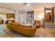 Living room with a large couch, oversized shelving, and steps to another room at 374 Beaumont Farms Dr, Sharpsburg, GA 30277