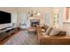 Comfortable living room with hardwood floors and a brick fireplace at 374 Beaumont Farms Dr, Sharpsburg, GA 30277
