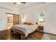Bright main bedroom with rustic barn door to en-suite bathroom and beautiful hardwood floors at 374 Beaumont Farms Dr, Sharpsburg, GA 30277