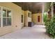 Covered patio with ceiling fan, wall-mounted TV, and a view of the lush green backyard at 374 Beaumont Farms Dr, Sharpsburg, GA 30277