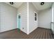 Inviting back porch with gray siding, wood flooring and bright blue door at 852 Washington Sw St, Atlanta, GA 30315
