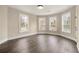 Spacious bedroom with wood floors, three windows, and plenty of natural light at 852 Washington Sw St, Atlanta, GA 30315