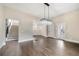 Bright dining room featuring dark wood floors, modern chandelier, and stairway access at 852 Washington Sw St, Atlanta, GA 30315