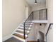 Upward view of staircase with wood and white steps and iron railings at 852 Washington Sw St, Atlanta, GA 30315