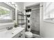 Well-lit bathroom with a sleek vanity, modern fixtures and a tiled shower with glass door at 1082 Green Valley Nw Dr, Conyers, GA 30012