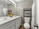 Stylish bathroom with double sinks, brick-style tile, and ample counter space at 1082 Green Valley Nw Dr, Conyers, GA 30012