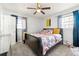 Bright bedroom features a ceiling fan, windows and beautiful floral comforter bedding at 1082 Green Valley Nw Dr, Conyers, GA 30012