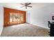Inviting bedroom featuring wood paneling, a large window seat, and neutral carpet at 1082 Green Valley Nw Dr, Conyers, GA 30012