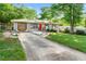 Charming single-story home with a well-maintained lawn and inviting red front door at 1082 Green Valley Nw Dr, Conyers, GA 30012