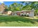 Cozy single-story home with a green lawn, mature trees, and a welcoming facade at 1082 Green Valley Nw Dr, Conyers, GA 30012
