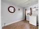 Functional laundry room with a modern washer, wood-look flooring, and shelving at 1082 Green Valley Nw Dr, Conyers, GA 30012