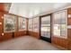 Cozy sunroom with natural light from multiple windows and wood paneled walls at 1082 Green Valley Nw Dr, Conyers, GA 30012