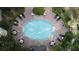 Aerial view of the community pool with chairs, tables, and surrounding mature trees at 11 Perimeter E Ctr # 1203, Dunwoody, GA 30346