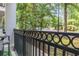 Cozy balcony featuring a decorative iron railing with views of lush landscaping and mature trees at 11 Perimeter E Ctr # 1203, Dunwoody, GA 30346