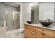 Stylish bathroom featuring a tiled shower, dual vessel sinks, and wood cabinets at 11 Perimeter E Ctr # 1203, Dunwoody, GA 30346