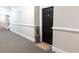 Hallway featuring carpeting and neutral paint leading to Unit 1308 with a welcome mat at 11 Perimeter E Ctr # 1203, Dunwoody, GA 30346