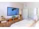 Comfortable main bedroom boasting a TV, stylish dresser, and an open doorway leading to an en-suite bathroom at 11 Perimeter E Ctr # 1203, Dunwoody, GA 30346