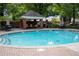 Community pool with ample seating and lounging options surrounded by lush, mature trees at 11 Perimeter E Ctr # 1203, Dunwoody, GA 30346
