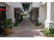 Picturesque open air walkway with covered archways, lush plants and flowers, and brick pavers at 11 Perimeter E Ctr # 1203, Dunwoody, GA 30346
