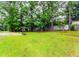 View of a grassy backyard with a basketball hoop, enclosed with a wooden fence at 201 Smithstone Path, Fayetteville, GA 30214