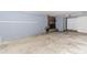 Unfinished basement with exposed concrete floor, brick fireplace, and potential for customization at 201 Smithstone Path, Fayetteville, GA 30214