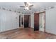Bedroom featuring wood floors, ceiling fan, and access to attached bathroom at 201 Smithstone Path, Fayetteville, GA 30214