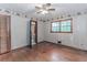 Bedroom has hardwood floors, ceiling fan, closet, and natural light from the window at 201 Smithstone Path, Fayetteville, GA 30214