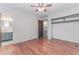 Bedroom featuring hardwood floors, a ceiling fan, and access to ensuite bathroom at 201 Smithstone Path, Fayetteville, GA 30214