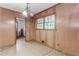 Cozy dining room features paneled walls, patterned flooring, and a view into the kitchen at 201 Smithstone Path, Fayetteville, GA 30214