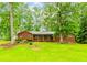 Charming brick ranch-style home with green shutters and a covered front porch on a spacious lot at 201 Smithstone Path, Fayetteville, GA 30214