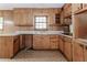 Retro kitchen showcasing wood cabinets, laminate countertops, and a stainless steel sink at 201 Smithstone Path, Fayetteville, GA 30214