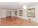 Bright living room with hardwood floors, natural light from multiple windows, and a vintage chandelier at 201 Smithstone Path, Fayetteville, GA 30214