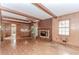 Inviting living room with wood paneling, fireplace, exposed ceiling beams and sliding glass doors at 201 Smithstone Path, Fayetteville, GA 30214