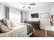 Comfortable bedroom features ceiling fan, dresser, tv and large window at 2700 Pine Tree Ne Rd # 2204, Atlanta, GA 30324