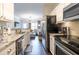 Modern kitchen flowing into the living room with stainless steel appliances and granite countertops at 2700 Pine Tree Ne Rd # 2204, Atlanta, GA 30324