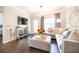 Bright living room featuring hardwood floors, a comfy couch, and a stylish mirrored cabinet at 2700 Pine Tree Ne Rd # 2204, Atlanta, GA 30324