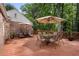 Inviting back deck featuring ample seating with umbrellas and a brick home exterior, perfect for outdoor entertaining at 4105 Peachtree Dunwoody Ne Rd, Atlanta, GA 30342
