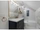 Stylish bathroom featuring a marble countertop vanity, bathtub, and a glass paneled shower at 4105 Peachtree Dunwoody Ne Rd, Atlanta, GA 30342