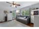 Well-lit bedroom with hardwood floors, a daybed, built-in shelves, and two large windows at 4105 Peachtree Dunwoody Ne Rd, Atlanta, GA 30342