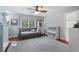 Bright bedroom with a twin bed, storage, hardwood floors, and a large window at 4105 Peachtree Dunwoody Ne Rd, Atlanta, GA 30342