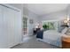Bright bedroom with bay window and closet, wood paneled walls, and hardwood floors at 4105 Peachtree Dunwoody Ne Rd, Atlanta, GA 30342