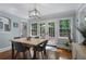 Bright dining area featuring hardwood floors, natural light, and views to outdoor patio at 4105 Peachtree Dunwoody Ne Rd, Atlanta, GA 30342