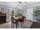 Traditional dining room with hardwood floors, neutral rug, natural light, and stylish light fixture at 4105 Peachtree Dunwoody Ne Rd, Atlanta, GA 30342